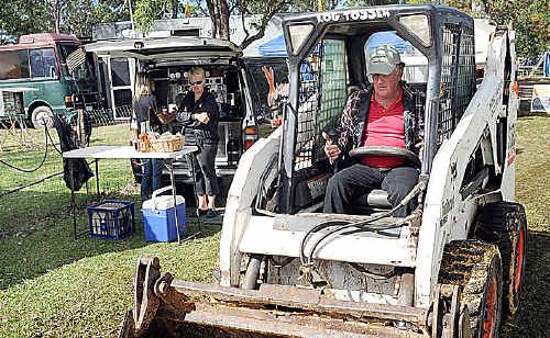 Noel Hanson spreads sawdust to cover the mud after the deluge at Torbanlea race track overnight. Noel Hanson spreads sawdust to cover the mud after the deluge at Torbanlea race track overnight.
